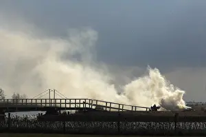 Smoke: Reed farmer is binding reed for covering roofs