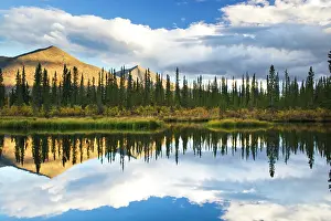 Yukon: Reflection of clouds and the Ogilvie Mountains in autumn at