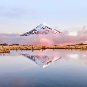 Howse: Reflection in Pouakai Tarn lake, pink clouds around
