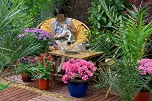 Tables: Resting woman on a flowered garden terrace