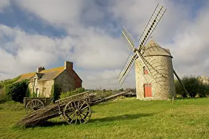 Cart: Restored French windmill with old wood cart in foreground