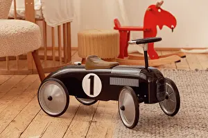 Decorated: Retro vintage racing black children's car in sty