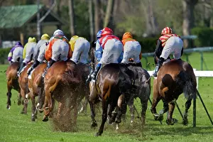 Jockey: Riders and Racehorses galloping around racecourse