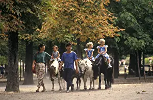 Jardin: Riding on miniature ponies in the Jardin du Luxembourg