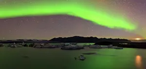 Moonlight: Rising moon and Aurora Borealis over icebergs