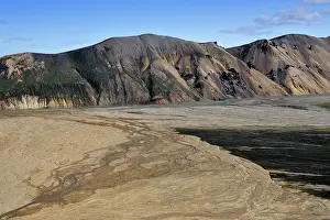 Geothermic: River delta in front of mountains in vulcanic landscape