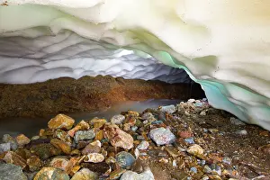 Landmannalaugar: River under glacier with colored rocks on the shore