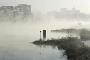 Breakwaters: The river IJssel is covered with fog on a cold wintermorning