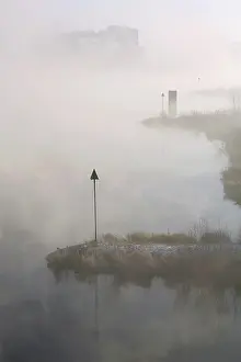 Overijssel: The river IJssel is covered with fog on a cold wintermorning