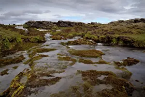Shutter: River running through volcanic landscape