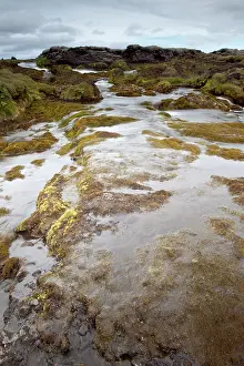 Shutter: River running through volcanic landscape