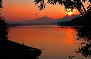 Mekong: River scene at sunset with boat on Mekong