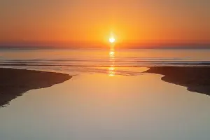 160517: River Verkean streams in the Baltic sea at sunrise