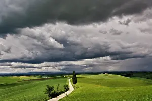 Looming: Road and storm clouds, rural Tuscany region