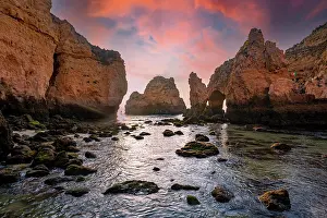 Algarve: Rock formations in the sea, dawn, sandstone cliff