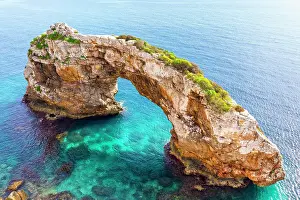 Cala: Rock gate Es Pontas in the sea, near Cala Santayi