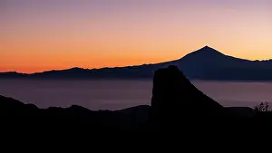 Butte: Rock tower Los Roques at sunrise, view to the volcano