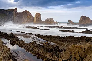 Flooded: A rocky and wild coast with stormy waves hitting the shore