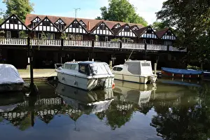 Thames: Row of Boathouses with balcony and with boats moored