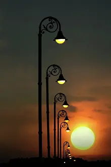 Repeating: Row of repeating street lights silhouetted