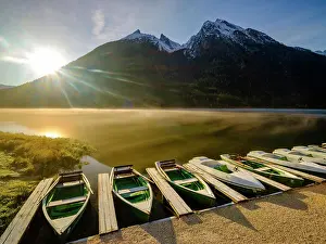 Rowing: Rowing boats at Hintersee with morning fog at sunrise