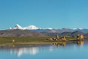 Tibet: Ruins by a lake on Tibetan Plateau, Dhaulagiri (8167m)
