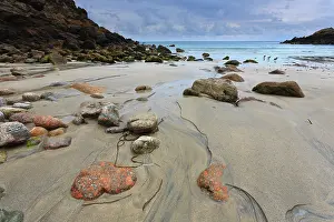Augustus: Running water to sea between colored stones and rocks and th