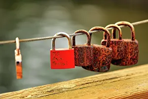 Metal: Rusty love locks, bridge railing at the village
