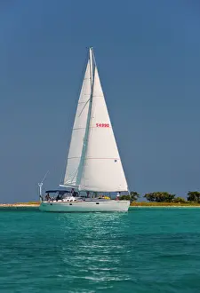 Laughing: A sail boat sailing by Laughing Bird Cay