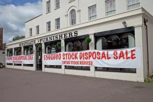 Shops: Sale notices in furnishing shop window offering