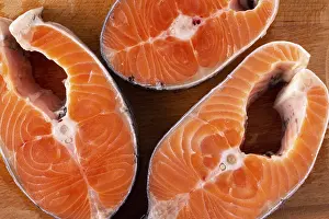 Section: Salmon steaks on a wooden board, close-up