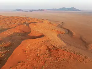 Dune: Sand dunes and isolated mountain ridges at the edge of the Namib Desert