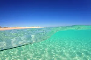 Rippled: Sand ripples - over and under water shot of a sun