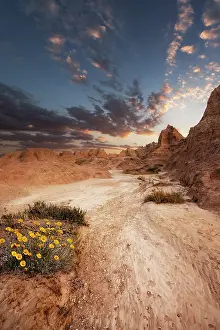 Dakota: Sandy path leading to the striking peaks or hoodoos