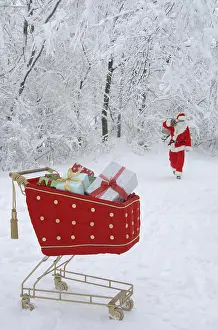 Shopping: Santa Claus in a snowy forest with a shopping cart