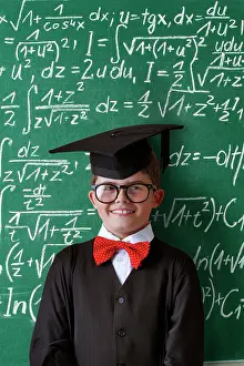 Board: Schoolboy wearing a graduation cap, glasses and