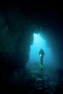 Dives: scuba diver on a cave entrance Madeira Island Portugal Atlan