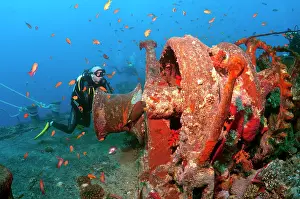 Ships: Scuba diver looking at winch of shipwreck SS Thistlegorm