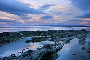Magellan: Seascape at dusk - pink clouds at dusk over rocky