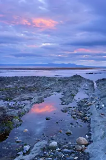 Magellan: Seascape at dusk - pink clouds at dusk over rocky