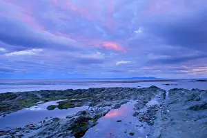 Magellan: Seascape at dusk - pink clouds at dusk over rocky