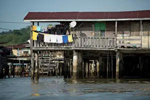 Plank: Shack on stilts with washing in river