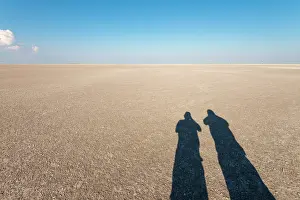 Cracked: Shadows of men in the Makgadikgadi Pans, Botswana