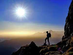 Mountaineer: Silhouette of a mountaineer on an exposed path in