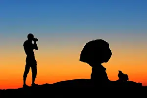 Ventures: Silhouette - photographer takes a photo of rock