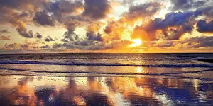 Reflected: The sky with colourful clouds reflected in the mudflat