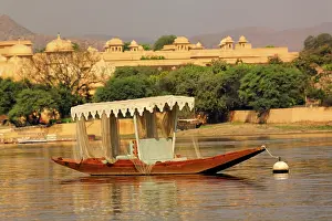 Moored: Small boat, and the Oberoi Udaivila hotel