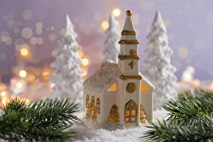 Christianity: Small church with candles and white trees as snowy