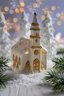 Christianity: Small church with candles and white trees as snowy