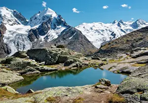 Engadin: Small mountain lake on Fuorcla Surlej with Piz Roseg